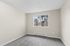 bedroom 2 in B1 renovated floorplan at Timber Flats windows and carpeted