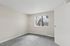 primary bedroom in B1 renovated floorplan at Timber Flats windows and carpeted