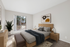 Virtually staged bedroom at Bridge Lane with a bed, dresser, side table and art and windows