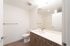 Bathroom at Orrin with white counters, wood cabinets and flooring