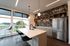 Orrin resident lounge kitchen with fridge, sink and island and bar seating