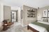Timber flats bedroom with a bed, chair, shelves and art