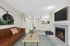 Virtually staged living room at Timber Flats with a couch, table, chair, tv