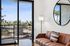 Living room at ASA with couch, mirror, and view outside