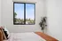 Bedroom at ASA with a bed, plant and window with view outside