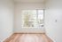 Living room at Lyra with a large window and hardwood floors