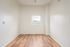 One Bedroom at Lyra Apartments - bedroom with window and hardwood floors