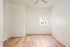 One-Bedroom at Lyra Apartments - bedroom with window, ceiling fan and hardwood floors