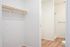 One-Bedroom at Lyra Apartments - view into the closet and bathroom with a shelf and space to hang clothes