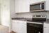One-Bedroom at Lyra Apartments - closeup of kitchen with grey countertops and stainless steel appliances