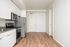 One-Bedroom at Lyra Apartments - view from living room into kitchen and entryway