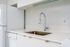 Cassi Apartments - kitchen with white appliances and white countertops and cabinets