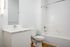 Cassi Apartments - bathroom with shower/tub white countertops and cabinets