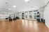 Yoga studio at Orrin with a wall of mirrors, weights and fitness balls with a door to the outdoor area