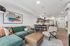 Orrin Apartments unit interior with wood cabinets and wood floors, a couch, ottoman and chair