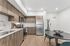 Orrin Apartments kitchen interior with wood cabinets and wood floors, white counters and backsplash