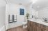 Bathroom at Orrin with white counters, wood floors, wood cabinets, shower/tub and toilet