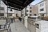 Covered area in the courtyard at Orrin with two barbeques and areas for seating