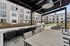 Covered area in the courtyard at Orrin with two barbeques and areas for seating