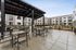 Covered area in the courtyard at Orrin with two barbeques and areas for seating