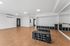 Yoga studio at Orrin with a wall of mirrors, weights and fitness balls with a door to the outdoor area