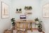 Virtually staged office at Lyra with a lot of plants, books, desk and chair