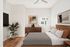 Virtually staged baedroom at Lyra with a bed, dresser, lamp, art