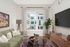 Virtually staged apartment at Lyra with a couch, tv, coffee table, rug and window