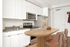 Virtually staged apartment at Lyra with a table, chairs and fruit bowl