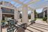 Community area with seating, partial shade, and sunlight.