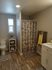 Neat bathroom with a large mirror and neutral tones at Lakeside Place.