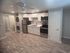 Open-concept kitchen with white cabinetry at Lakeside Place.