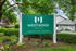 Property Sign with trees and a garden.