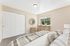 virtually staged bedroom with closet, carpet, and window.