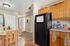 virtually staged kitchen with table, fridge, coffee machine, and plant