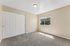 bedroom with carpet, window, closet.