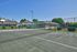 Fenced community tennis and sports court area on a sunny day at CAMPBELL PARK.