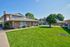 Expansive green lawn space between residential buildings at CAMPBELL PARK.
