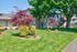 Beautifully landscaped garden island feature in front of buildings at CAMPBELL PARK.