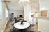 Virtually staged dining area and kitchen setup showing modern design at CAMPBELL PARK.