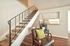View from a furnished living space looking up a wooden staircase at CAMPBELL PARK.