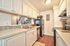 Long kitchen counter layout equipped with updated major appliances at CAMPBELL PARK.