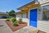 Blue front door accenting a modern apartment building exterior at CAMPBELL PARK.