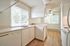 Classic kitchen layout with white cabinetry and solid countertops at CAMPBELL PARK.