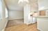 Unfurnished living area with wood-style flooring looking toward a kitchen at CAMPBELL PARK