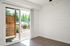 Patio sliding doors with wooden floor and ceiling fan.