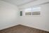 Bedroom with wooden floor and window and circuit breaker.