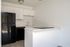 Kitchen with counters, sink, fridge, and oven.