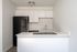 Kitchen with fridge, sink, counter, and oven.
