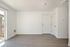 Living area with wooden floor, doors, patio, and vents.